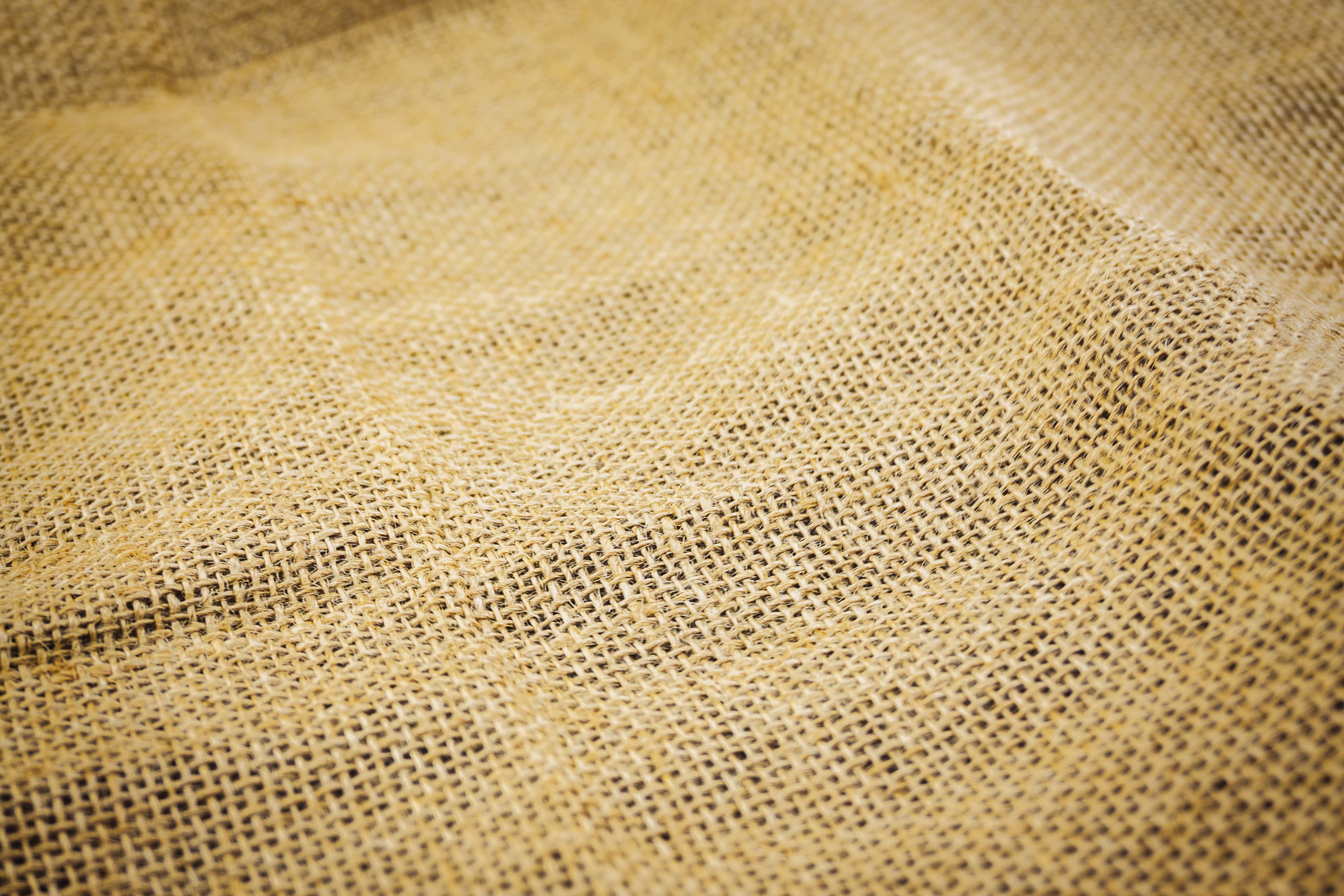 Close-up of woven jute hessian showing weave structure and mesh aperture